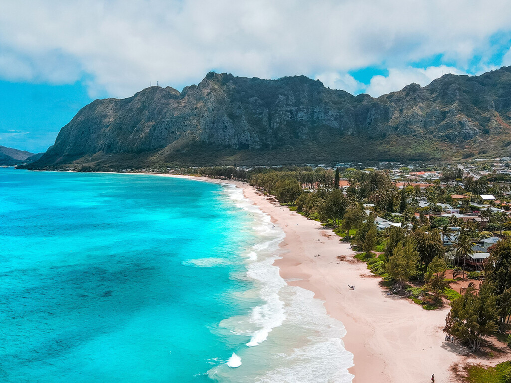 Scenic Waimanalo Beach With A Turquoise Seascape With Foamy Waves Washing The Shore In Hawaii